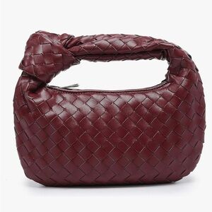 Woven knotted burgundy faux leather handbag